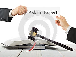 Law book and wooden judges gavel on table in a courtroom or law enforcement office. Lawyer Hands holding business card