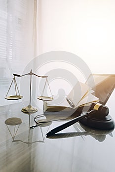 law books and scales of justice on desk in library of law firm. jurisprudence legal education concept