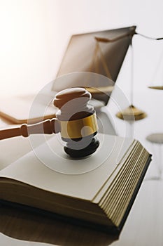 law books and scales of justice on desk in library of law firm. jurisprudence legal education concept