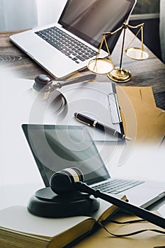 law books and scales of justice on desk in library of law firm. jurisprudence legal education concept