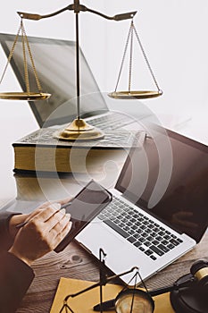 law books and scales of justice on desk in library of law firm. jurisprudence legal education concept