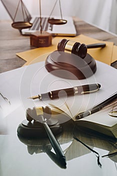 law books and scales of justice on desk in library of law firm. jurisprudence legal education concept