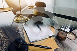 law books and scales of justice on desk in library of law firm. jurisprudence legal education concept