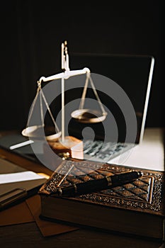 law books and scales of justice on desk in library of law firm. jurisprudence legal education concept