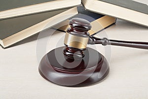 Law concept - Book with wooden judges gavel on table in a courtroom or enforcement office.