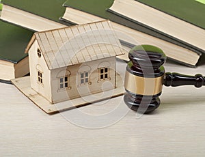 Law concept - Books, model house with wooden judge gavel on table .Copy space for text