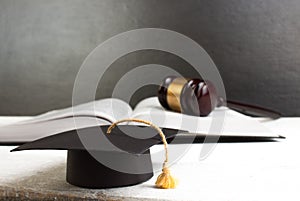 Law concept, education concept - Open law book with a wooden judges gavel on table in a courtroom or law enforcement office. Copy