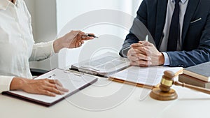 Law concept The man in dark blue suit, a lawyer, sitting at his desk and trying to prepare to give law consultation to his