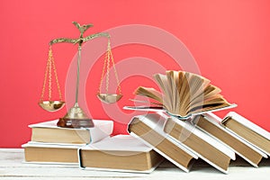 Law concept - open book of laws, judge\'s gavel, scales, Themis statue in a courtroom or law enforcement office.