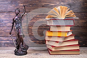 Law concept - Open law book scales, Themis statue on table in a courtroom or law enforcement office photo