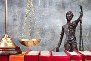 Law concept - Open law book scales, Themis statue on table in a courtroom or law enforcement office photo