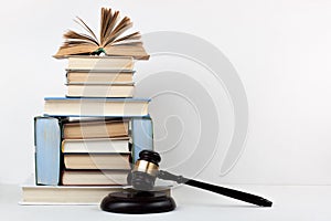Law concept open book with wooden judges gavel on table in a courtroom or law enforcement office, white background. Copy