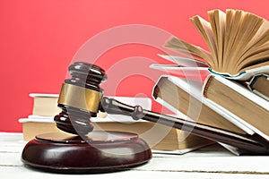 Law concept - Open law book, Judge\'s gavel, scales, Themis statue on table in a courtroom or law enforcement office.