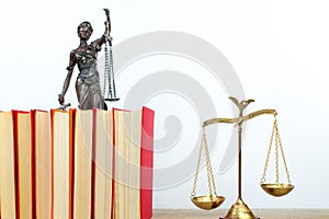 Law concept - Open law book, Judge's gavel, scales, Themis statue on table in a courtroom or law enforcement office