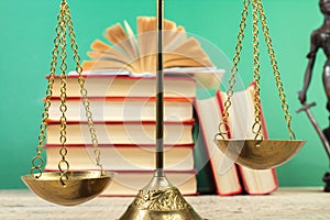 Law concept - Open law book, Judge\'s gavel, scales, Themis statue on table in a courtroom or law enforcement office