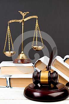 Law concept - Open law book, Judge\'s gavel, scales, Themis statue on table in a courtroom or law enforcement office.