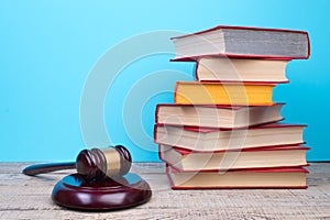 Law concept - Open law book, Judge\'s gavel, scales, Themis statue on table in a courtroom or law enforcement office