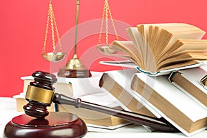 Law concept - Open law book, Judge\'s gavel, scales, Themis statue on table in a courtroom or law enforcement office