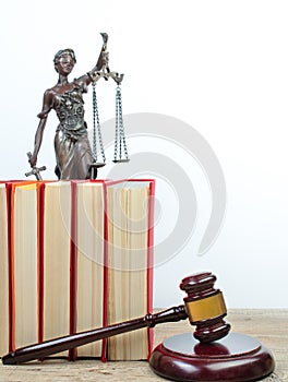 Law concept - Open law book, Judge\'s gavel, scales, Themis statue on table in a courtroom or law enforcement office