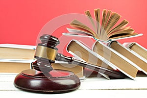 Law concept - Open law book, Judge\'s gavel, scales, Themis statue on table in a courtroom or law enforcement office