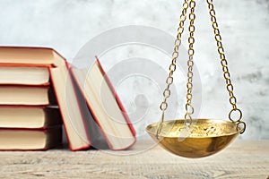 Law concept - Open law book, scales on table in a courtroom or law enforcement office