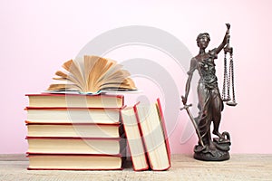 Law concept - Open law book scales, Themis statue on table in a courtroom or law enforcement office