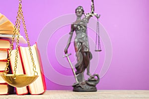 Law concept - Open law book, scales, Themis statue on table in a courtroom or law enforcement office