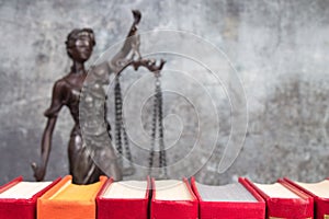 Law concept - Open law book scales, Themis statue on table in a courtroom or law enforcement office
