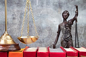 Law concept - Open law book scales, Themis statue on table in a courtroom or law enforcement office