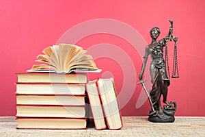 Law concept - Open law book scales, Themis statue on table in a courtroom or law enforcement office