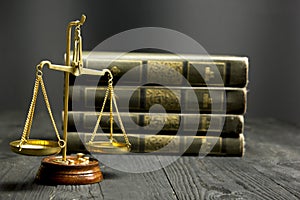 Law concept - Open law book with a wooden judges gavel on table in a courtroom or law enforcement office  on