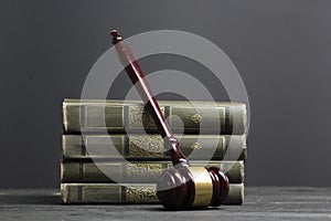 Law concept - Open law book with a wooden judges gavel on table in a courtroom or law enforcement office isolated on