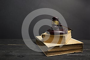 Law concept - Open law book with a wooden judges gavel on table in a courtroom or law enforcement office isolated on white