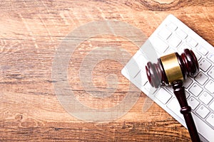 Law concept - Open law book with a wooden judges gavel on table in a courtroom or law enforcement office isolated on white