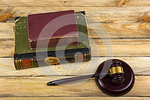 Law concept - Open law book with a wooden judges gavel on table in a courtroom or law enforcement office isolated on white