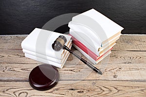 Law concept - Open law book with a wooden judges gavel on table in a courtroom or law enforcement office isolated on white