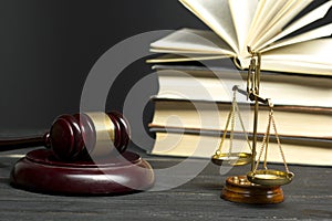 Law concept - Open law book with a wooden judges gavel on table in a courtroom or law enforcement office isolated on photo