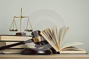 Law concept. Wooden judge gavel with law books ,scales of justice on table in a courtroom or enforcement office.