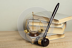 Law concept. Wooden judge gavel with law books ,scales of justice on table in a courtroom or enforcement office.