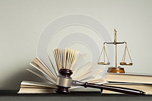Law concept. Wooden judge gavel,scales of justice and books on table in a courtroom or enforcement office.