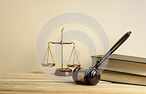 Law concept. Wooden judge gavel,scales of justice and books on table in a courtroom or enforcement office.