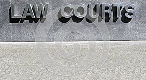 Law Courts sign in stainless steel, courthouse building, copy space