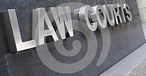 Law Courts sign in stainless steel, courthouse building