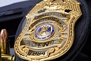 Law enforcement badge with gun, handcuffs and bullets