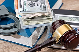 Law gavel with Dollars in book and handcuff