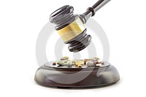 Law gavel and drugs, tablets and pills on the wooden sound block