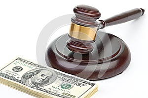 Law gavel on a stack of American money.
