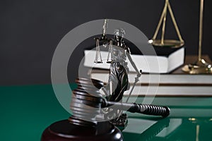 Law and Justice concept image, Lady Justice and gavel  on rustic books background