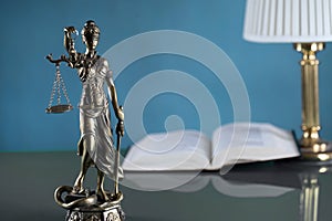 Law and Justice concept image, Lady Justice and gavel  on rustic books background