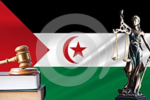 Law and justice in Western Sahara Statue of themis and the gavel of the judge against the background of the flag of